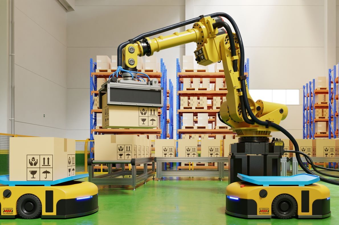 A yellow robot arm mounted on an automated guided vehicle beside shelving stacked with cartons
