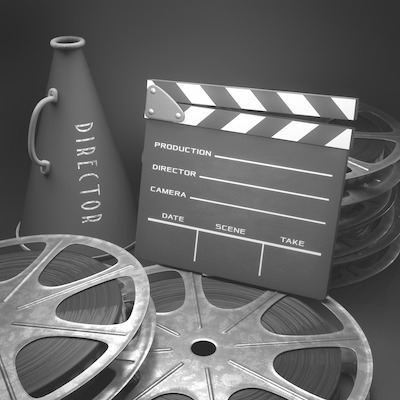 Film reels, a blank clapperboard and a director's megaphone