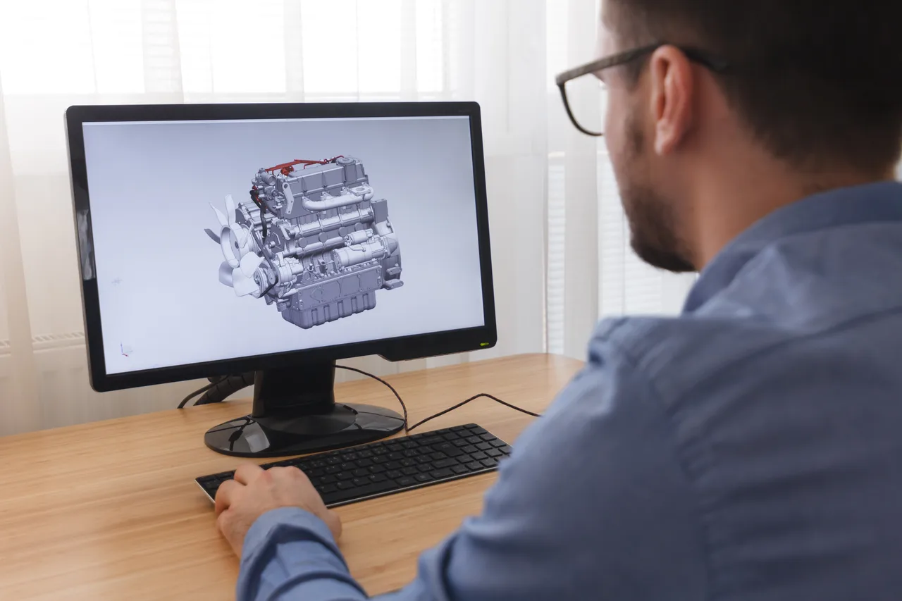 An engineer reviewing an engine model in design software