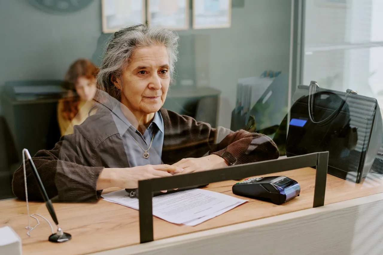 A customer completing a transaction at a bank teller window