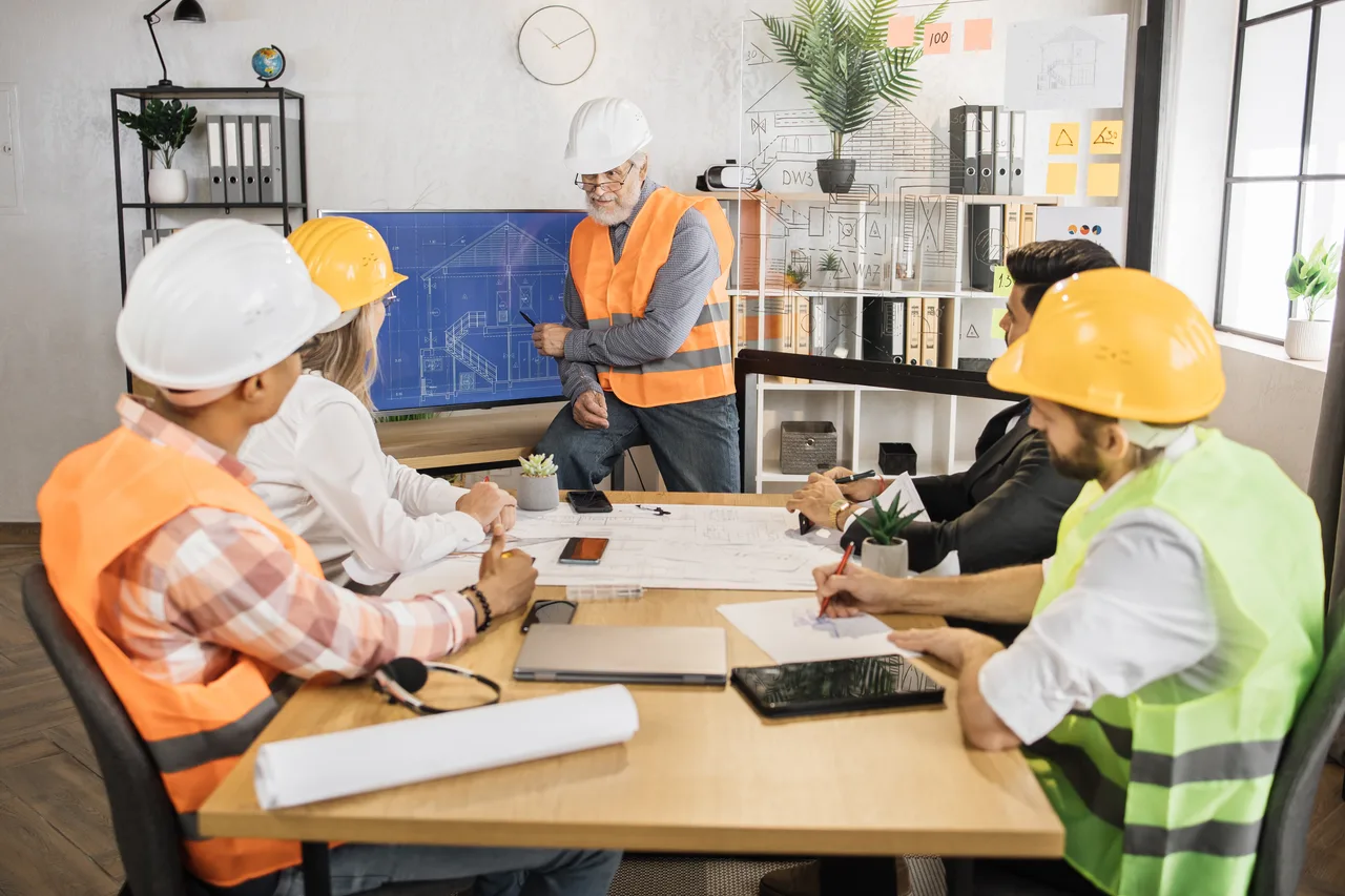 Engineers and site staff working through plans around a table