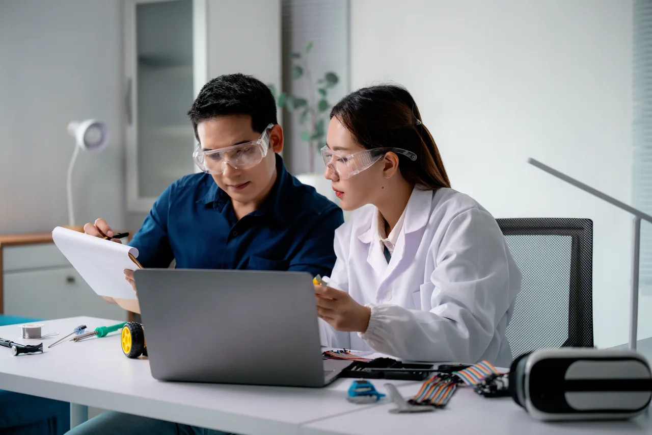 Two engineers building and testing a connected device