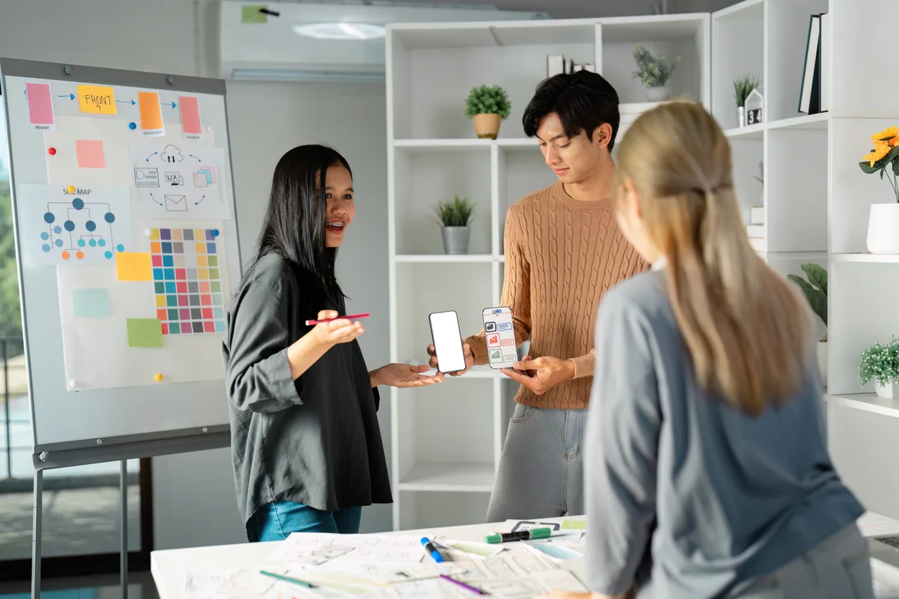 A product team planning together at a board of sticky notes