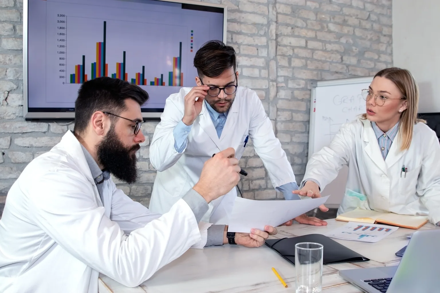 Clinicians reviewing a plan together in front of a chart