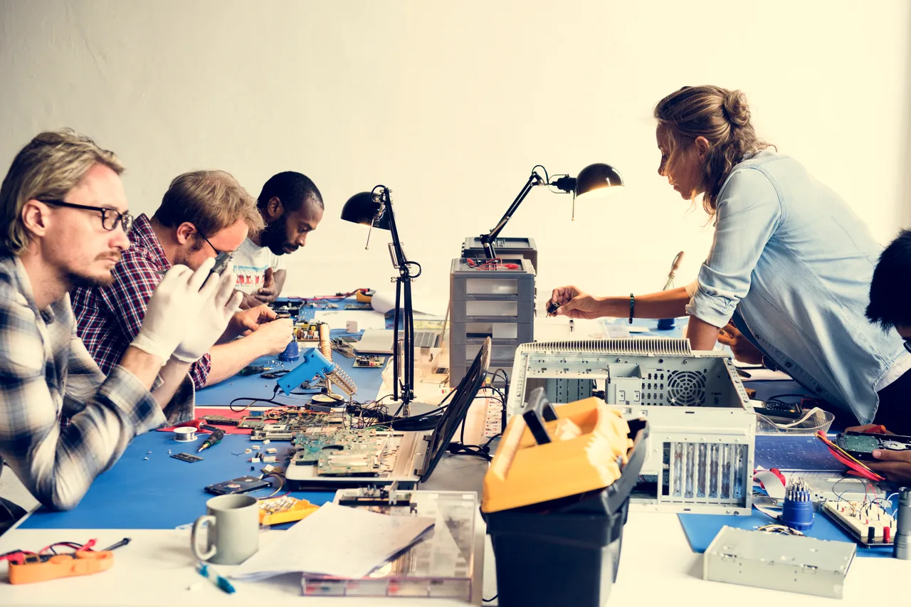 A hardware team working together at an electronics bench