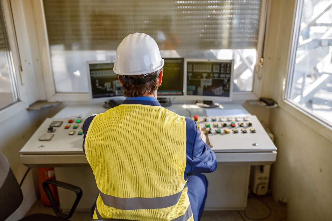 An operator monitoring a control panel at an energy site