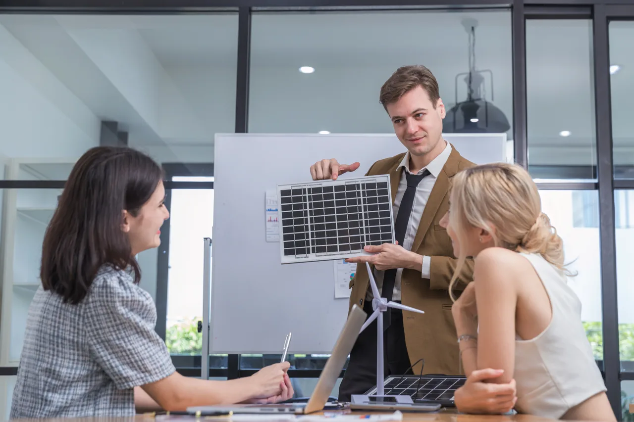 A team discussing a renewable energy project around a table