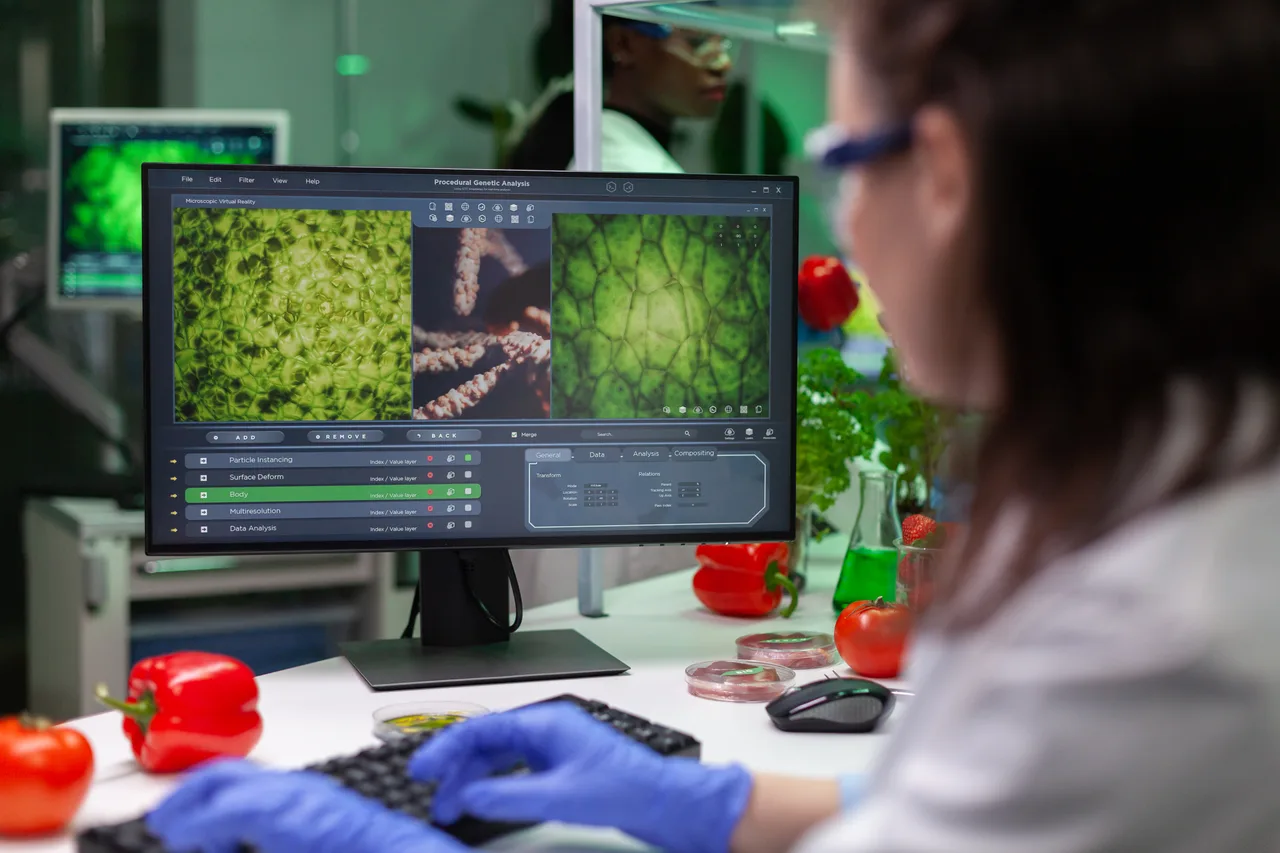 A food scientist reviewing sample imagery on a lab computer