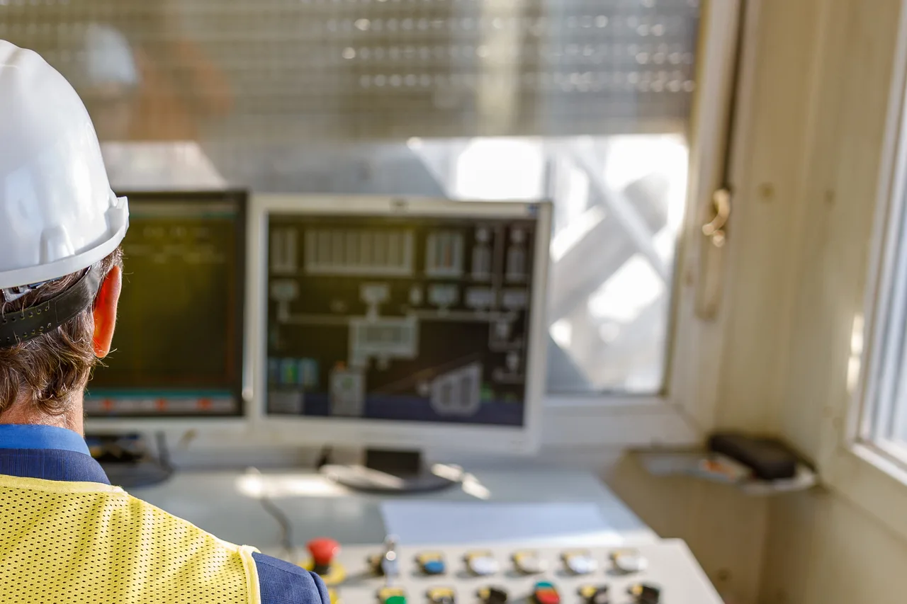 An operator overseeing site operations from a control room