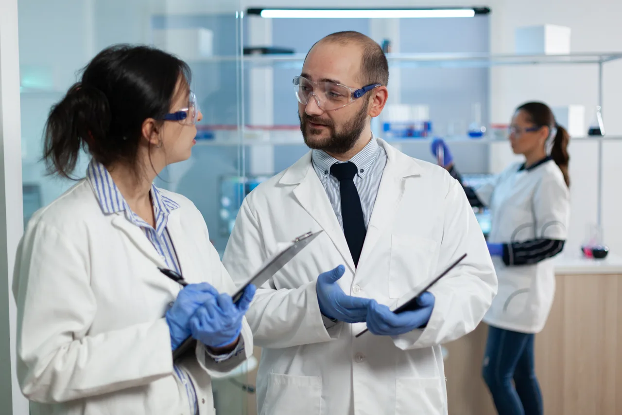 Two scientists discussing results in a pharmaceutical laboratory