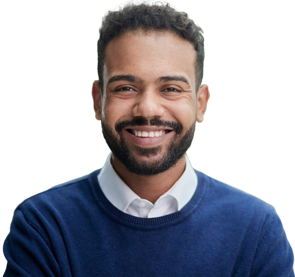A smiling engineer with a beard wearing a navy sweater over a white collared shirt
