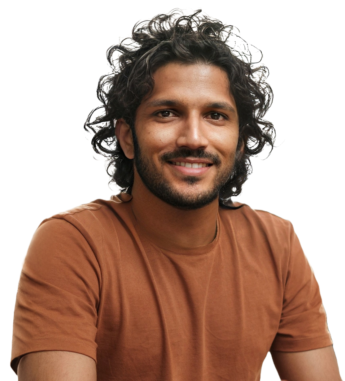 A smiling engineer with curly hair and a beard, wearing a rust-coloured T-shirt