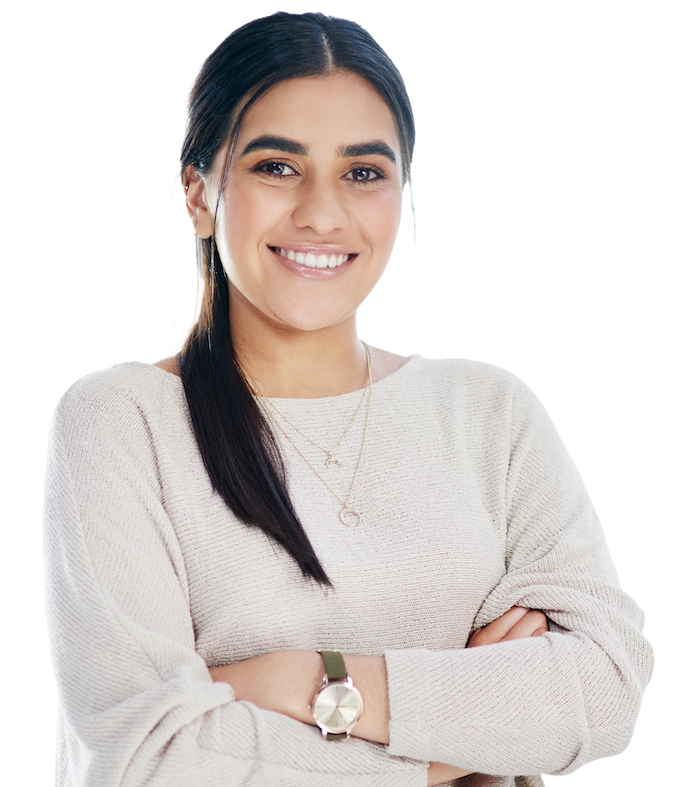 A smiling engineer in a cream sweater with folded arms