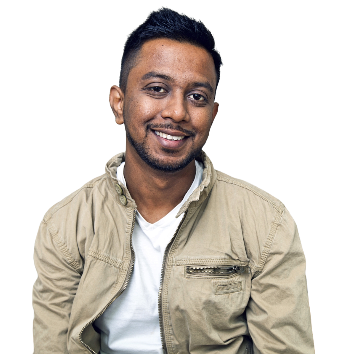 A smiling engineer with short dark hair and a trimmed beard, wearing a khaki jacket over a white T-shirt