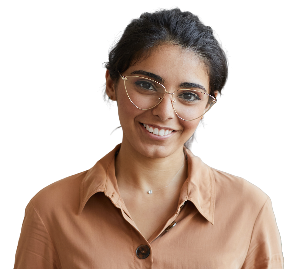 A smiling engineer with dark hair tied back and thin wire-framed glasses, in a light brown shirt