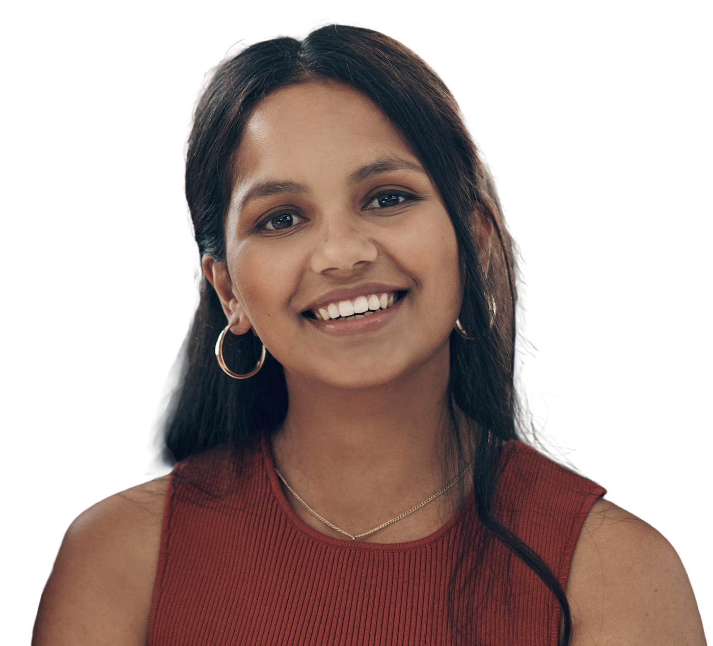 A smiling engineer with long dark hair and gold hoop earrings in a rust-red ribbed top