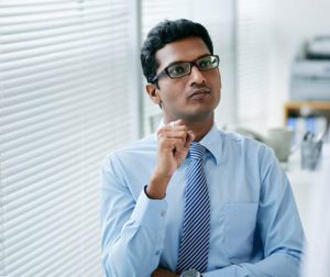 Portrait of pensive Indian businessman in office