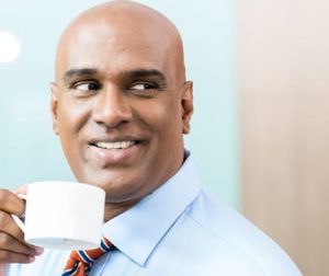 Indian Businessman with cup of coffee in office