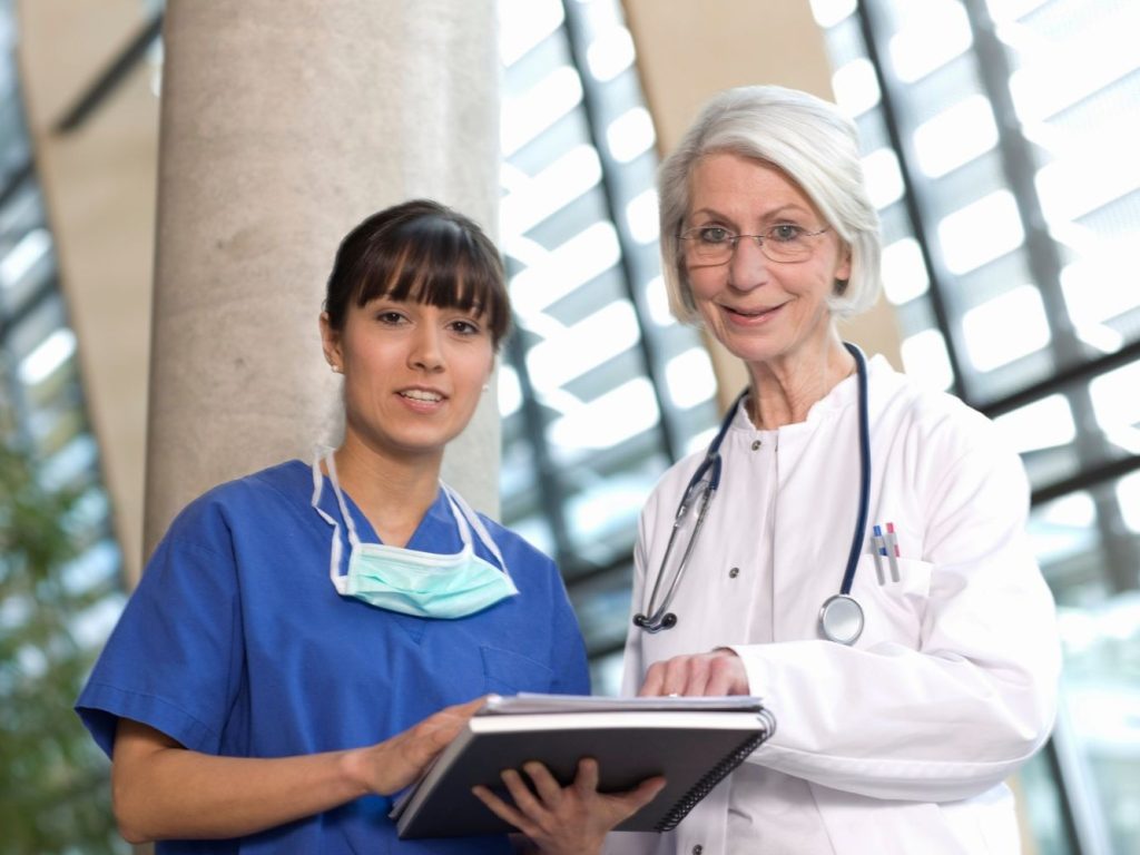 two-professionals-consult-over-patient-notes-indoo-2026-03-25-00-24-14-utc